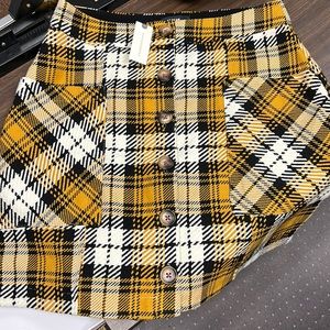 Plaid, mustard and cream, lined, button up skirt with pockets.